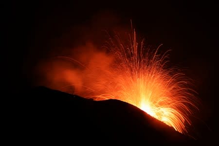 Lava spurts from the Stromboli volcano a day after an eruption unleashed a plume of smoke on the Italian island of Stromboli