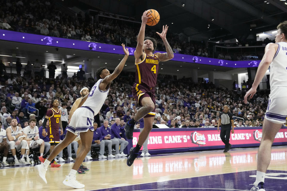 Minnesota guard Braeden Carrington (4) drives to the basket past Northwestern guard Blake Smith, front left, during the first half of an NCAA college basketball game in Evanston, Ill., Saturday, March 9, 2024. (AP Photo/Nam Y. Huh)