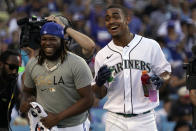 American League's Julio Rodriguez, of the Seattle Mariners, right, smiles next to Toronto Blue Jays' Vladimir Guerrero Jr. during the MLB All-Star baseball Home Run Derby, Monday, July 18, 2022, in Los Angeles. (AP Photo/Mark J. Terrill)