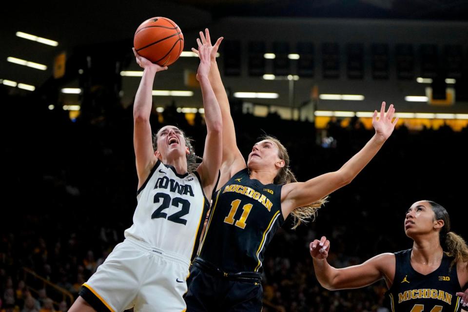 PHOTO: Iowa guard Caitlin Clark (22) pulls up for a shot as Michigan guard Greta Kampschroeder (11) defends during the second half of an NCAA college basketball game, Feb. 15, 2024, in Iowa City, Iowa. (Matthew Putney/AP)