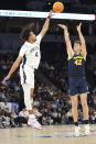 Michigan forward Will Tschetter (42) shoots over Penn State forward Puff Johnson (4) during the first half of an NCAA college basketball game during the first round of the Big Ten Conference men's tournament Wednesday, March 13, 2024, in Minneapolis. (AP Photo/Abbie Parr)