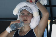 Barbora Krejcikova of the Czech Republic pours water over herself during a break in her quarterfinal against Madison Keys of the U.S. at the Australian Open tennis championships in Melbourne, Australia, Tuesday, Jan. 25, 2022. (AP Photo/Andy Brownbill)