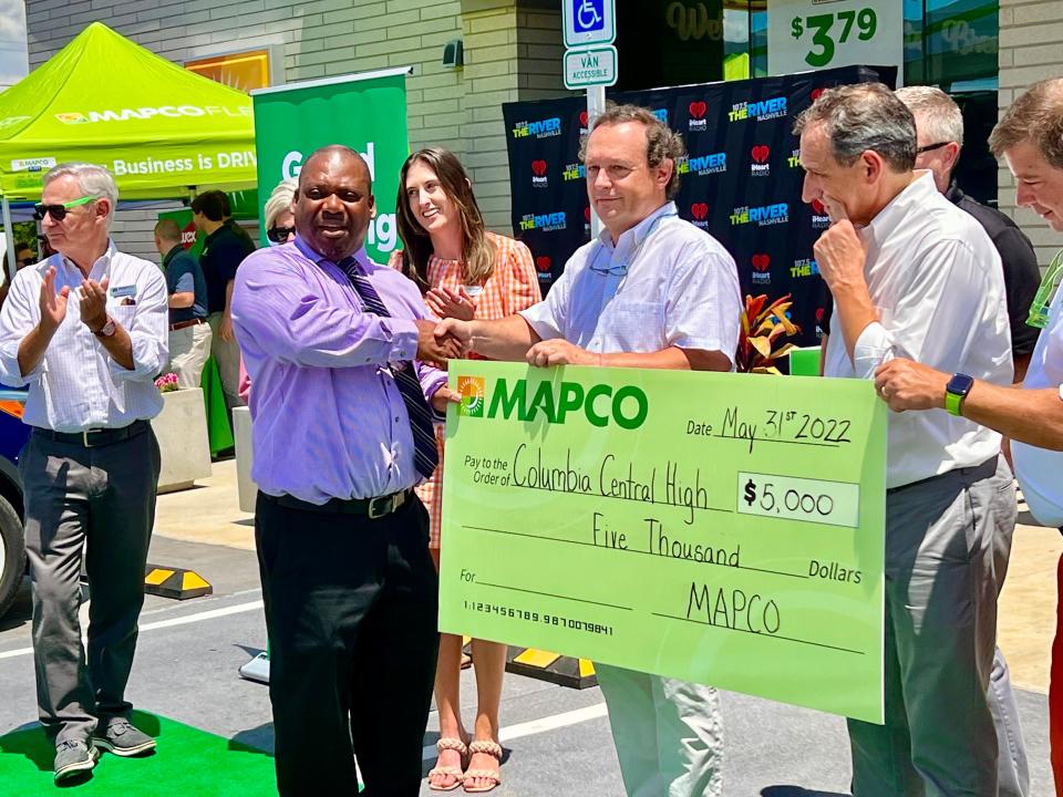 MAPCO CEO Frederic Chaveyriat presents a $5,000 check to Central High School principal Kevin Eady during the gas station/convenience mart's grand opening Tuesday, May 30, 2022.