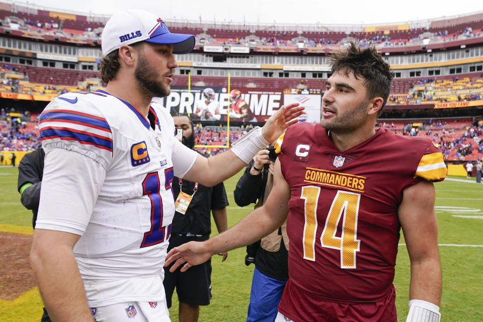 Buffalo Bills quarterback Josh Allen (17) and Washington Commanders quarterback Sam Howell (14) meet on the field at the end of an NFL football game, Sunday, Sept. 24, 2023, in Landover, Md. Buffalo won 37-3. (AP Photo/Andrew Harnik)