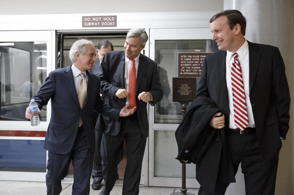 From left, Sen. Bob Corker, R-Tenn., Sen. Sheldon Whitehouse, D-R.I., and Sen. Chris Murphy, D-Conn., arrive for a procedural vote in the Senate on a bill that would extend unemployment benefits, at the Capitol in Washington, Monday, Jan. 6, 2014. Benefits expired for many long-term unemployed Americans on Dec. 28 after lawmakers did not extend the program as part of a bipartisan budget agreement. Sen. Jack Reed, D-R.I., is leading the effort to reauthorize the benefits for three months nationwide, but Republicans are balking however have balked at the proposed extension without offsets for the $6.5 billion that it will cost. (AP Photo/J. Scott Applewhite)