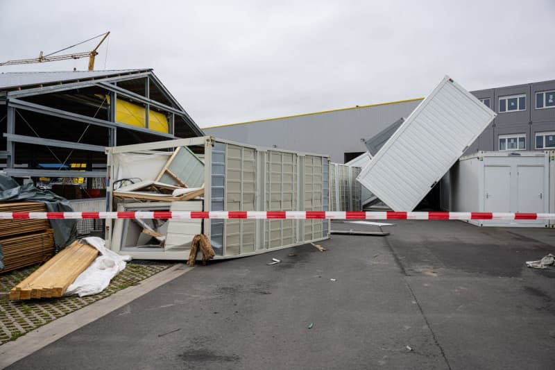 Containers lie overturned in the yard of a company that manufactures system and modular containers after a heavy storm in Telgte. Guido Kirchner/dpa