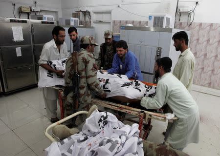 Soldiers help paramedics move the body of one of four Frontier Corps personnel killed by gunmen in Quetta, Pakistan, June 29, 2016. REUTERS/Naseer Ahmed