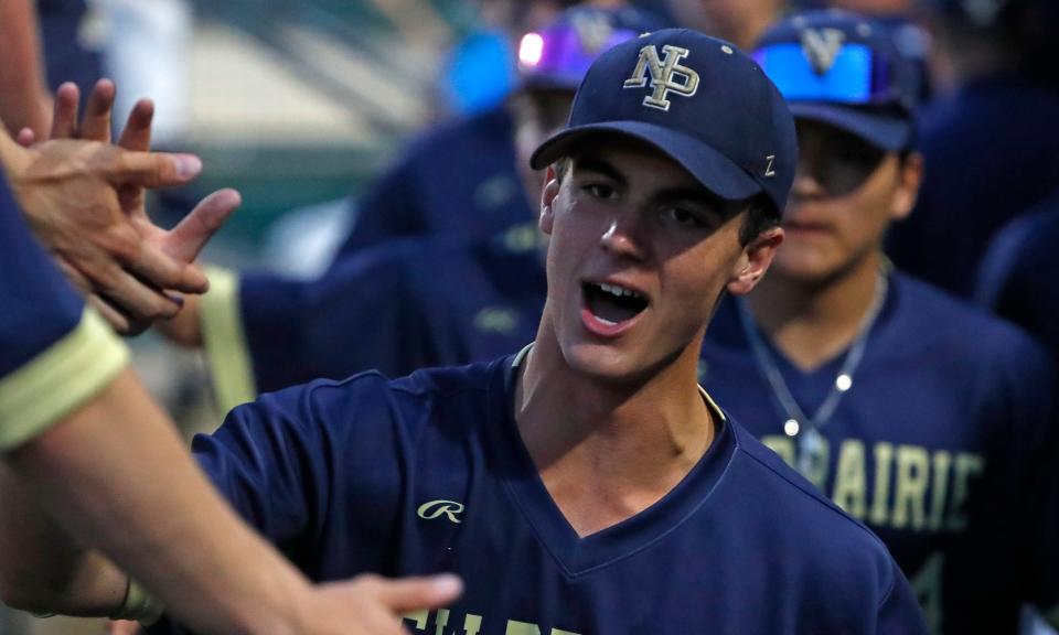 New Prairie Cougars Tyson Greenwood (24) celebrates with teammates during the IHSAA class 3A baseball state championship game against the Brebeuf Jesuit Braves, Friday, June 14, 2024, at Victory Field in Indianapolis. New Prairie Cougars won 7-2.