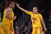 Southern California guard Endyia Rogers, right, gestures after hitting a 3-point shot as forward Kayla Overbeck stands nearby during the first half of the team's NCAA college basketball game against Oregon on Sunday, Feb. 16, 2020, in Los Angeles. (AP Photo/Mark J. Terrill)