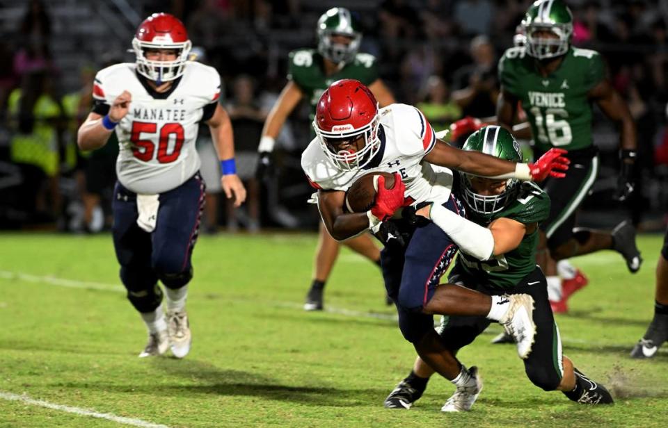 Manatee High’s Kei’shawn Smith pushes away from a Venice player on Friday, Oct. 6, 2023.