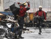 FILE - In this Nov. 21, 2018, file photo, a mining rescue team arrives for a regular shift at the Wujek coal mine in Katowice, in southern Poland. The coronavirus has ripped through Poland's coal mines, where men descend deep underground in tightly packed elevators and work shoulder-to-shoulder. The virus hot spots, centered in the southern Silesia region, have paralyzed an already-troubled industry, forcing many to stay home from work and triggering a three-week closure of many state-run mines. (AP Photo/Czarek Sokolowski, File)