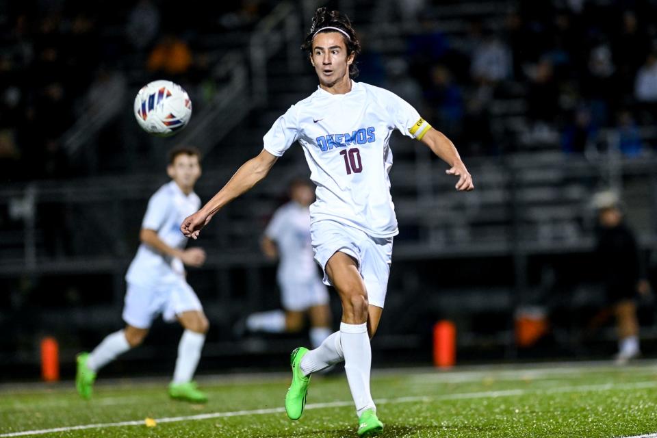 Okemos' Alex Gandhi moves the ball against Detroit Catholic Central during the first half on Tuesday, Oct. 25, 2022, at East Lansing High School.