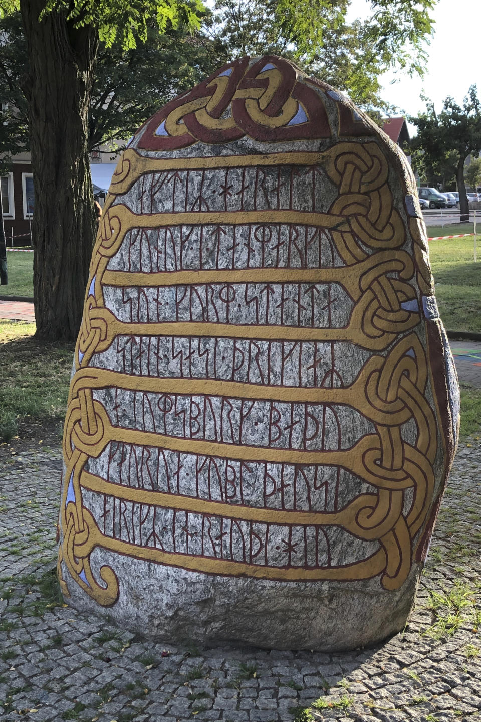 A view of a 2014 stone with runic inscription in memory of Danish 10th century King Harald “Bluetooth” Gormsson, in Wolin, Poland, Saturday, July 30,2022. More than 1,000 years after his death in what is now Poland, a Danish king whose nickname is known to the world through the Bluetooth technology is at the center of an archeological dispute. A Polish researcher and a Swedish archeologist claim that they have pinpointed the probable burial site for King Harald Bluetooth Gormsson in a small village in northwestern Poland, an area that once had ties with the Vikings. (AP Photo Monika Scislowska)