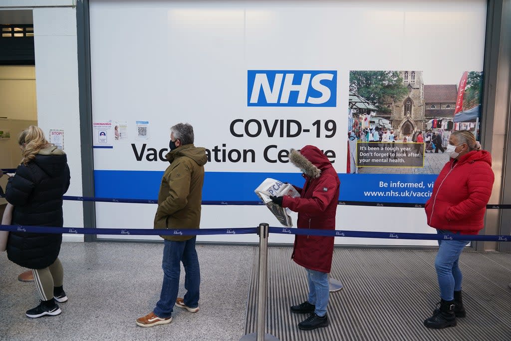 People queue to receive Covid-19 vaccinations at a site in Liberty shopping centre, Romford, east London (Yui Mok/PA) (PA Wire)