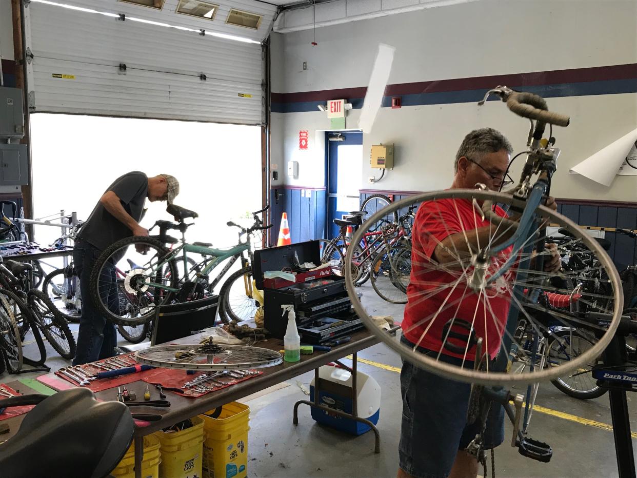 The Communicycle crew hard at working putting old bikes back on the street, ready to ride.