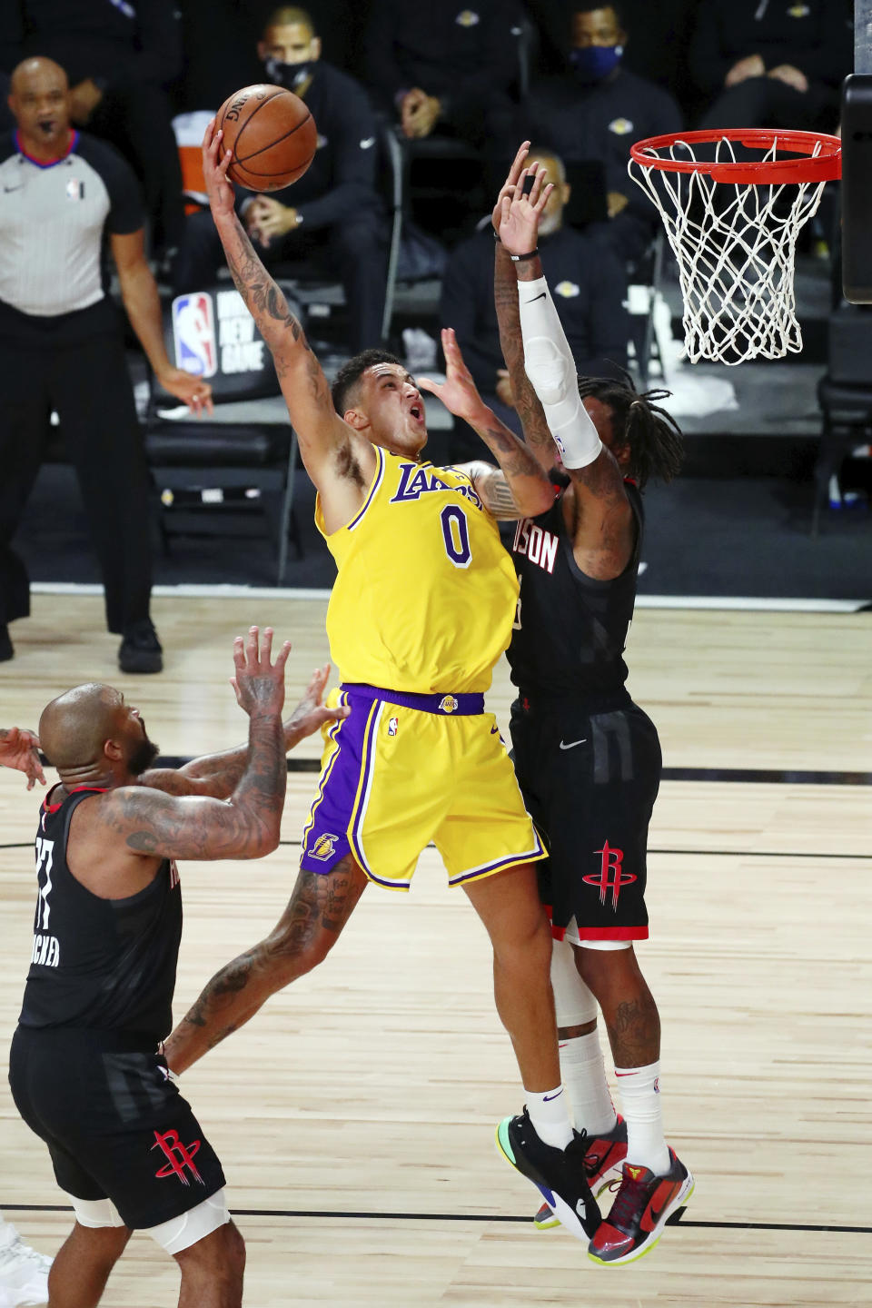 Houston Rockets forward Ben McLemore, right, fouls Los Angeles Lakers forward Kyle Kuzma (0) who makes a basket during the first half of an NBA basketball game Thursday, Aug. 6, 2020, in Lake Buena Vista, Fla. (Kim Klement/Pool Photo via AP)