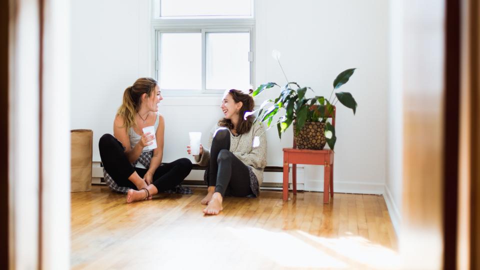 Two girls moving in a new house