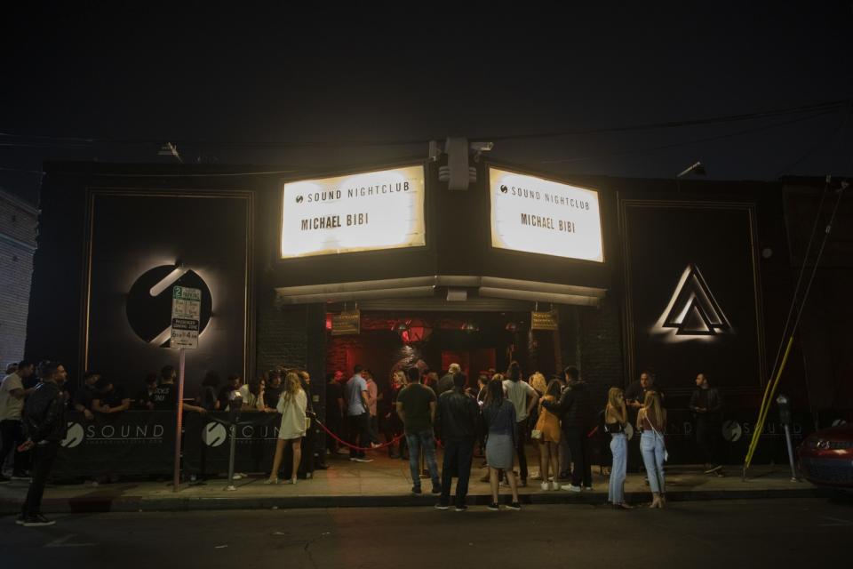 People gather outside a nightclub.