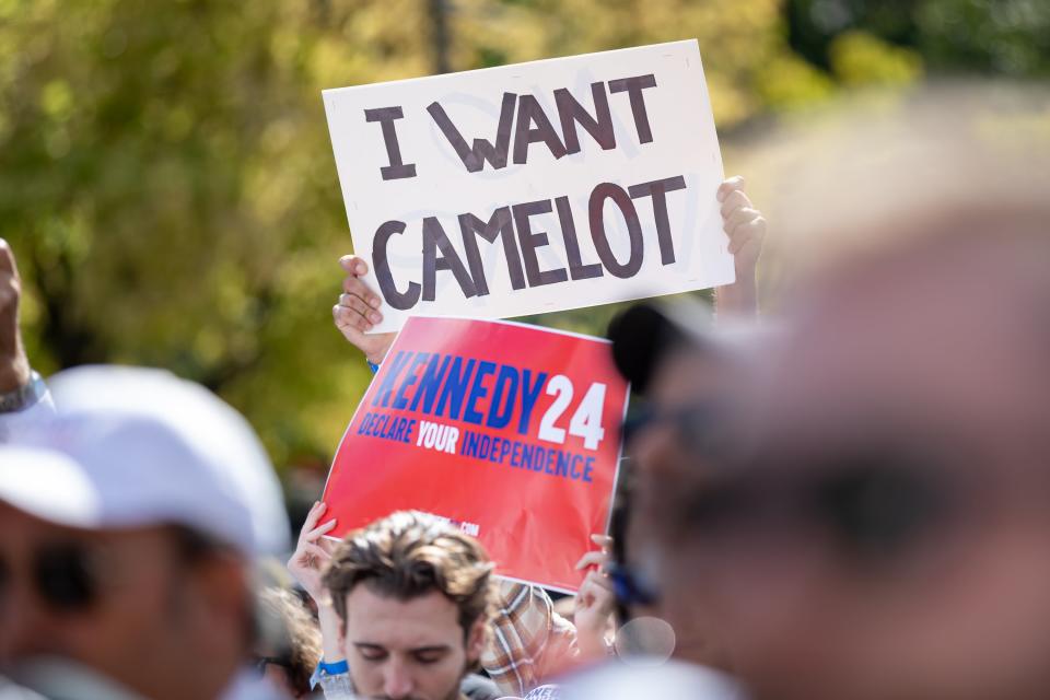 A Kennedy supporter holds a sign that reads: "I want Camelot."