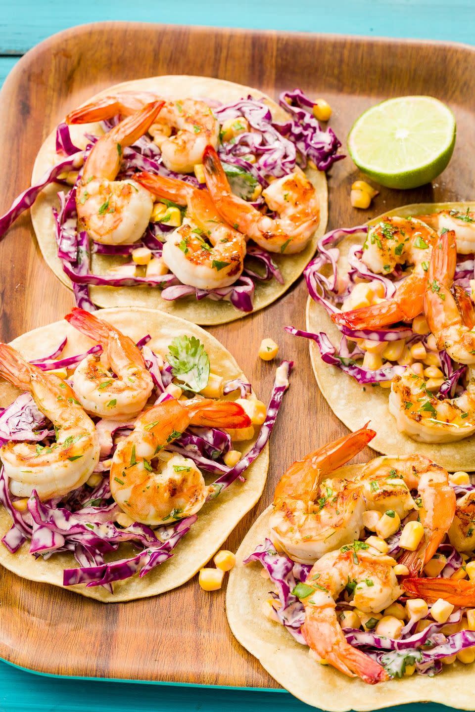 <p>There are no extraneous ingredients here—once you grab <a href="https://www.delish.com/cooking/recipe-ideas/g2768/shrimp-recipes/" rel="nofollow noopener" target="_blank" data-ylk="slk:shrimp;elm:context_link;itc:0;sec:content-canvas" class="link ">shrimp</a>, you've probably got almost everything to make these already! We left the tails on the shrimp for grilling, but feel free to take them off.</p><p>Get the <strong><a href="https://www.delish.com/cooking/recipe-ideas/recipes/a47499/grilled-shrimp-tacos-with-sriracha-slaw-recipe/" rel="nofollow noopener" target="_blank" data-ylk="slk:Grilled Shrimp Tacos With Sriracha Slaw recipe;elm:context_link;itc:0;sec:content-canvas" class="link ">Grilled Shrimp Tacos With Sriracha Slaw recipe</a></strong>.</p>