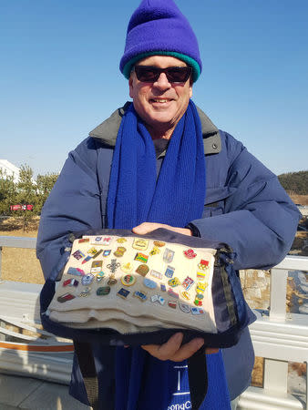 Olympic pin collector Bob Kalmuk, from California, displays his pins outside the Gangneung Ice Arena during the Pyeongchang 2018 Winter Olympics, Gangneung, South Korea February 13, 2018. REUTERS/Philip O'Connor