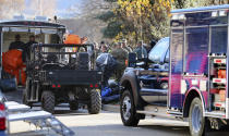 In this Nov. 22, 2016 photo, local and federal law enforcement agencies respond to a drug bust in Cottonwood Heights, Utah. The raid on Aaron Shamo’s home in the upscale suburb of Cottonwood Heights, agents found a still-running pill press in the basement, thousands of pills and more than $1 million in cash stuffed in garbage bags, according to court documents. (Scott G Winterton/The Deseret News via AP)