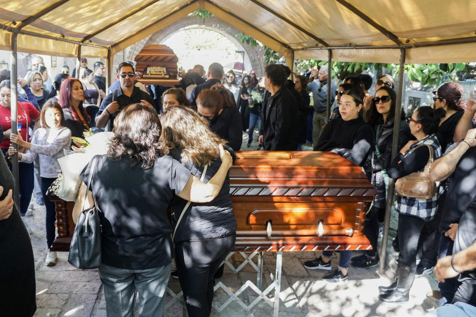 Friends and family attend a funeral procession for two murdered youths, in Salvatierra, Guanajuato state, Mexico, Tuesday, Dec 19, 2023. Survivors of a massacre in central Mexico told investigators that a group of people turned away from a holiday party on Sunday, returned later with gunmen who killed several attendees including the two youths, and wounded over a dozen. (AP Photo/Mario Armas)