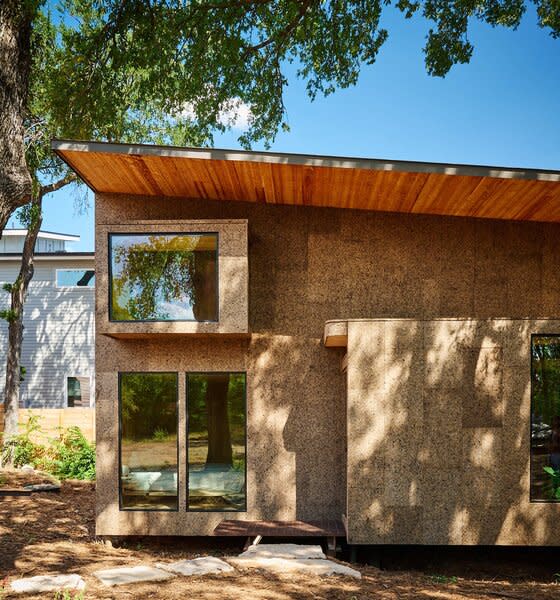 Stone pavers lead to the home’s entry vestibule, marked by a landing.