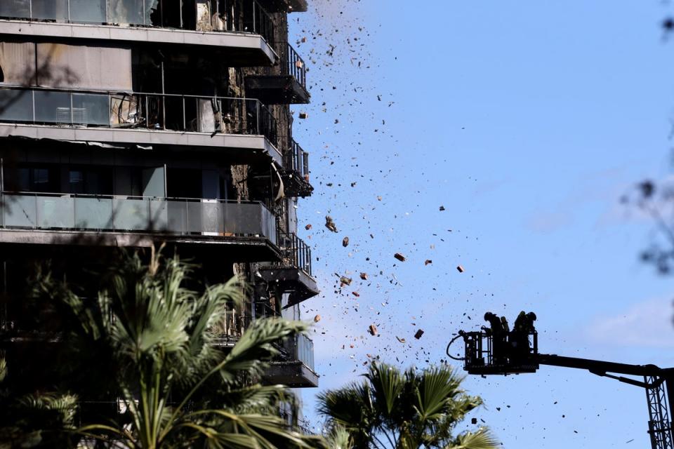 Debris flew out at firefighters who worked to put out the blaze (AP)