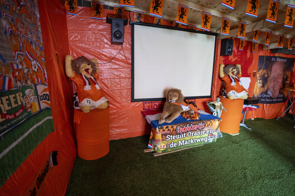 Some fans covered their garden and installed a screen to watch soccer matches as orange tarp, orange bunting, and Dutch national flags decorate Marktweg street in The Hague, Netherlands, Thursday June 13, 2024, one day ahead of the start of the Euro 2024 Soccer Championship. The Marktweg is one of several streets in the Netherlands that get an all-encompassing orange facelift during European Championships and World Cups when the national team, known as Oranje after the Dutch royal family and the color of their shirts, are playing. (AP Photo/Peter Dejong)