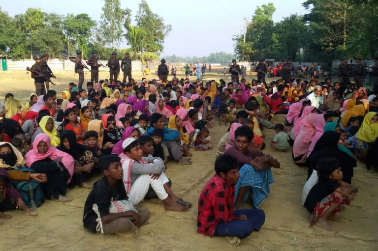 Rohingya Muslims from Myanmar, who tried to cross the Naf river into Bangladesh to escape sectarian violence, are kept under watch by Bangladeshi security officials in Teknaf on December 25, 2016