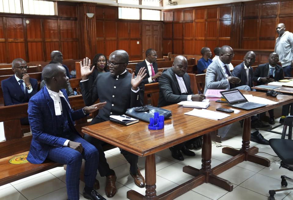 Lawyers react as Justice Chacha Mwita delivers judgement on a petition against the deployment of Kenyan forces to Haiti, at Milimani court in the capital Nairobi, Kenya, Friday, Jan. 26, 2024. A Kenyan court on Friday blocked the deployment of 1,000 police officers to Haiti, to help the Caribbean nation deal with gang violence. "A declaration is issued that the National Security Council has no mandate to deploy the National Police Service," Justice Chacha ruled. (AP Photo/Brian Inganga)