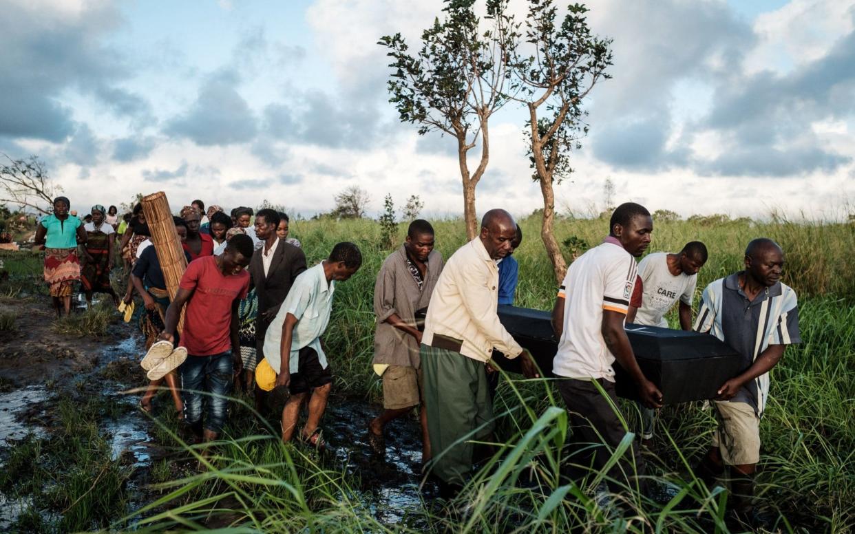 People carry a coffin near Beira, Mozambique - AFP