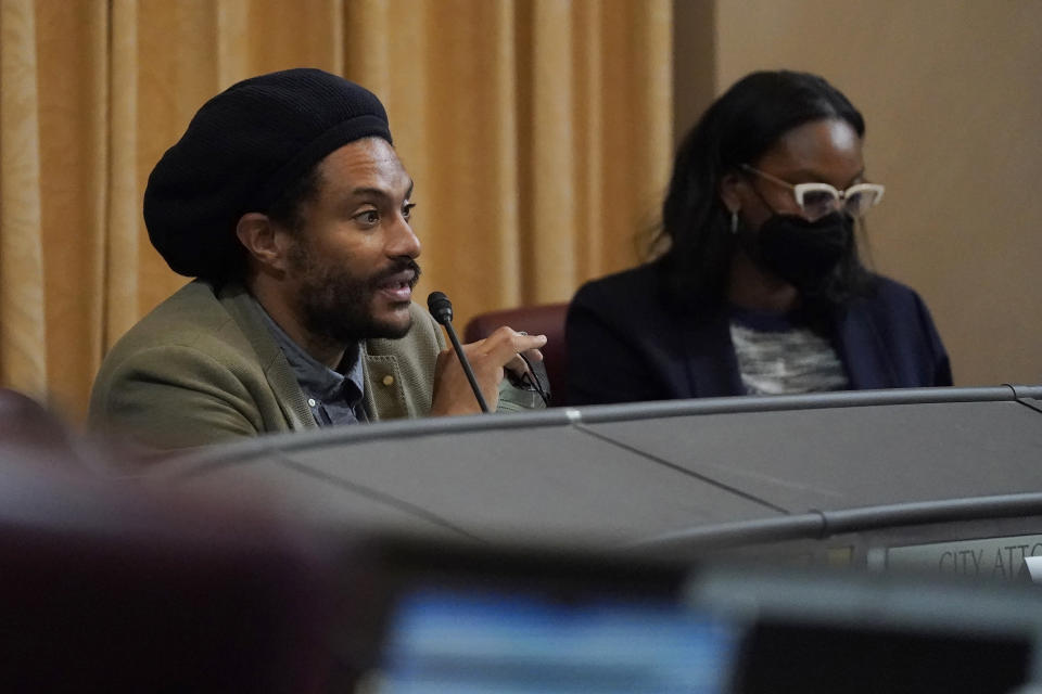 Task Force member Dr. Jovan Lewis, left, speaks next to Task Force Chair Kamilah Moore during a meeting by the Task Force to Study and Develop Reparation Proposals for African Americans in Oakland, Calif., Wednesday, Dec. 14, 2022. (AP Photo/Jeff Chiu)