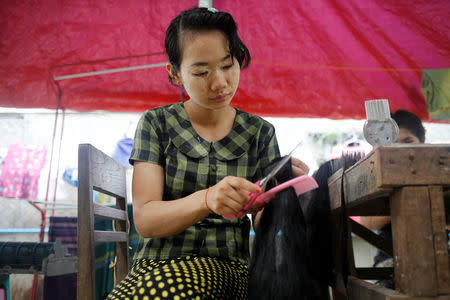 Workers clean the hair for export at Tet Nay Lin Trading Co. in Yangon, Myanmar, June 19, 2018. REUTERS/Ann Wang