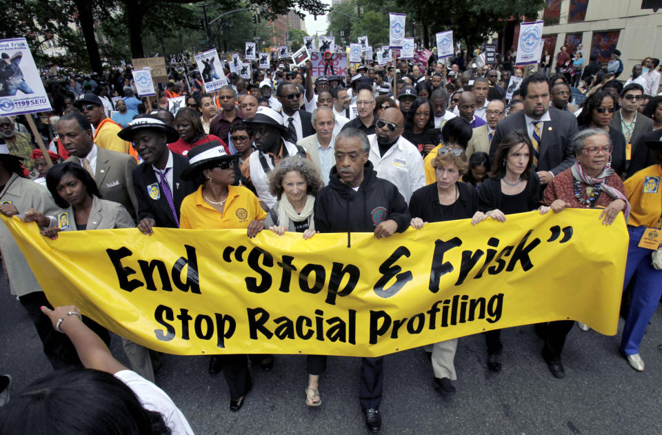 File-This photo from Sunday, June 17, 2012, shows Rev. Al Sharpton, center, with demonstrators during a silent march to end the "stop-and-frisk" program in New York. During the Bloomberg administration, civil rights groups went to court to end the NYPD's use of a tactic known as "stop and frisk," which involved detaining, questioning and sometimes searching people deemed suspicious by officers. (AP Photo/Seth Wenig, File)