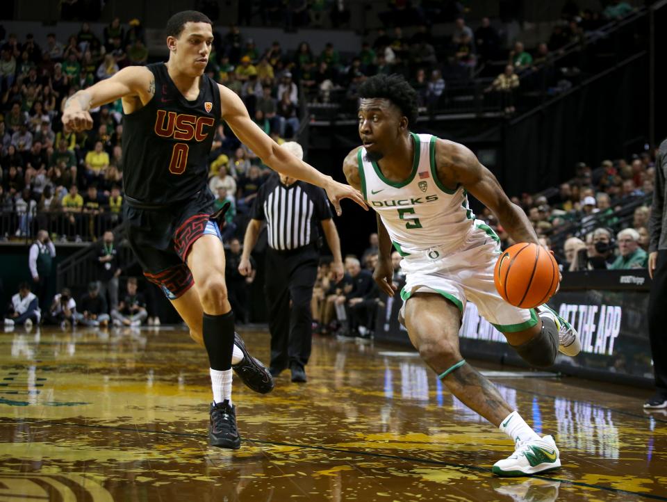 Oregon guard Jermaine Couisnard drives toward the basket under coverage from USC guard Kobe Johnson as the Oregon Ducks host the Southern California Trojans Feb. 9, at Matthew Knight Arena in Eugene.