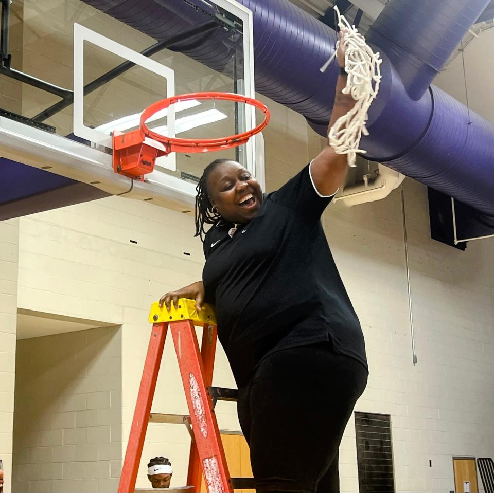 Africentric coach Janicia Anderson holds up the net as the Nubians celebrate their Division III district championship Thursday at Capital.