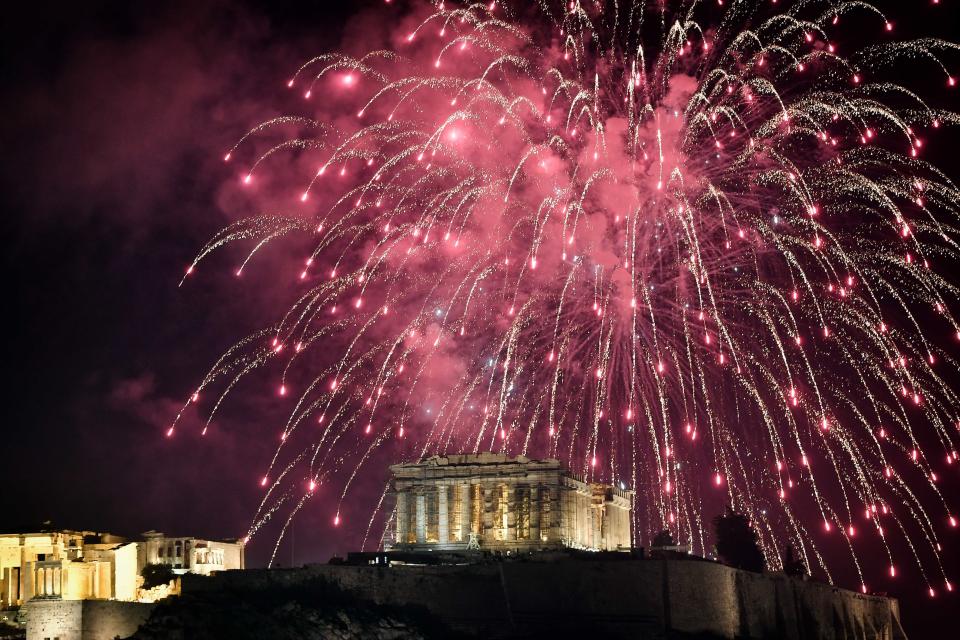 Fireworks explode over the Acropolis in Athens during New Year's celebrations on December 31, 2017. (Photo: LOUISA GOULIAMAKI via Getty Images)