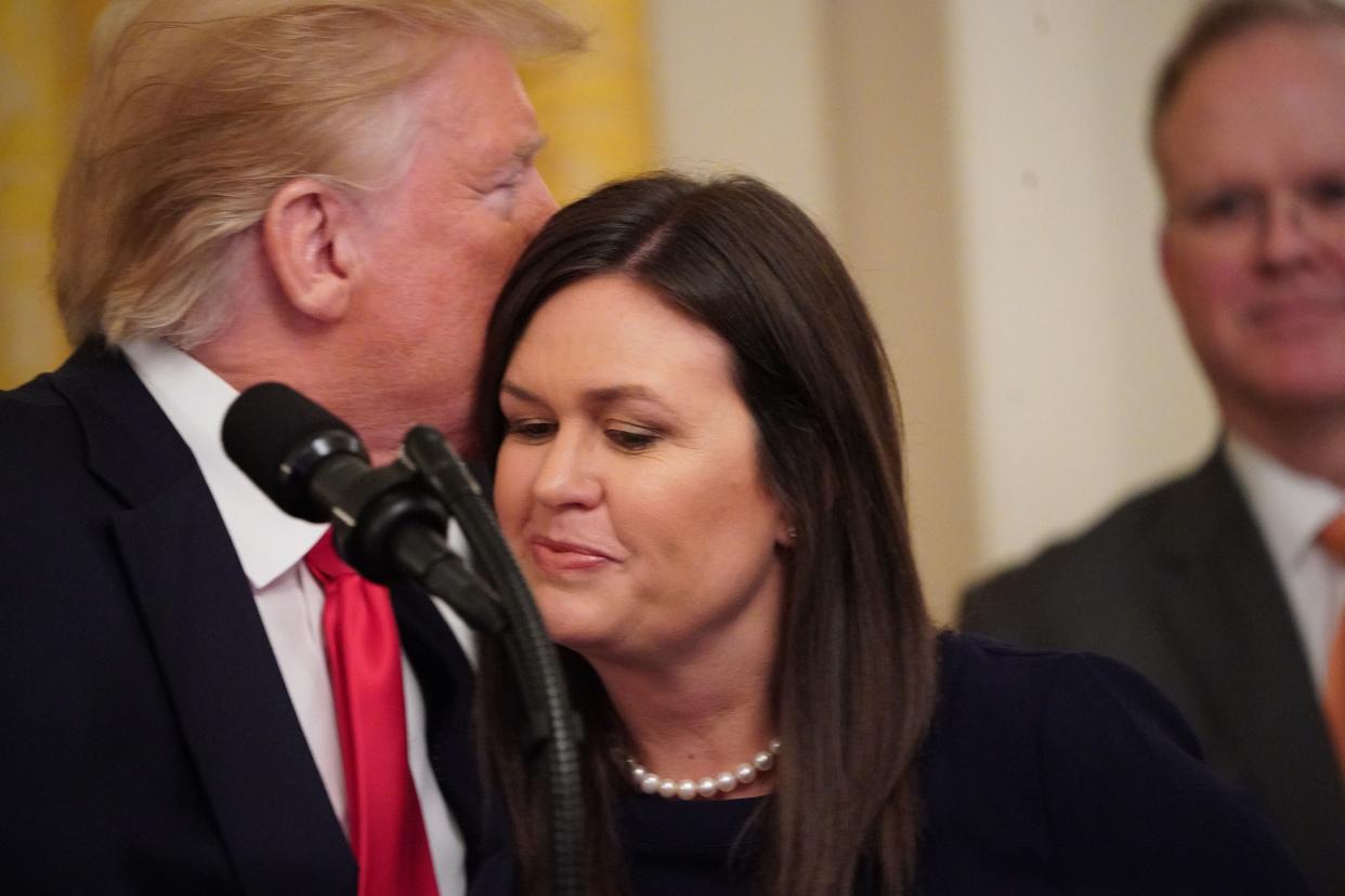 Outgoing White House Press Secretary Sarah Huckabee Sanders hugs US President Donald Trump during a second chance hiring and criminal justice reform event in the East Room of the White House in Washington, DC, June 13, 2019. - President Donald Trump on Thursday made the surprise announcement of the departure of spokeswoman Sarah Sanders, who has been widely criticized for her performance in the White House. "After 3 1/2 years, our wonderful Sarah Huckabee Sanders will be leaving the White House at the end of the month and going home to the Great State of Arkansas," Trump tweeted, adding that he hoped she would run for governor of her state. (Photo by MANDEL NGAN / AFP)        (Photo credit should read MANDEL NGAN/AFP/Getty Images)