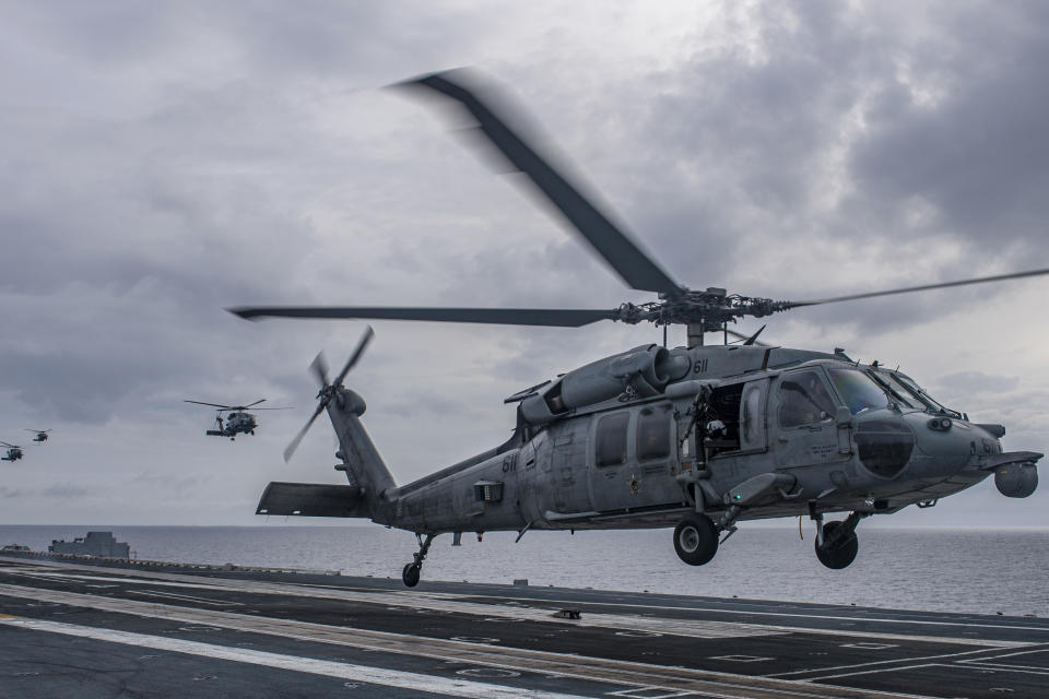 An MH-60S Sea Hawk helicopter lands aboard the aircraft carrier USS Nimitz in the South China Sea, Sunday, Feb. 12, 2023, as Nimitz in U.S. 7th Fleet was conducting operations. The 7th Fleet based in Japan said Sunday that the USS Nimitz aircraft carrier strike group and the 13th Marine Expeditionary Unit have been conducting “integrated expeditionary strike force operations” in the South China Sea. (Mass Communication Specialist 2nd Class Justin McTaggart/U.S. Navy via AP)