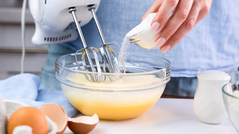 beating eggs with electric whisk