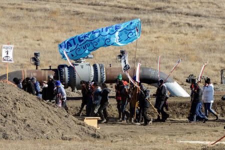 Protesters march along the pipeline route during a protest against the Dakota Access pipeline near the Standing Rock Indian Reservation in St. Anthony, North Dakota, U.S. November 11, 2016. REUTERS/Stephanie Keith