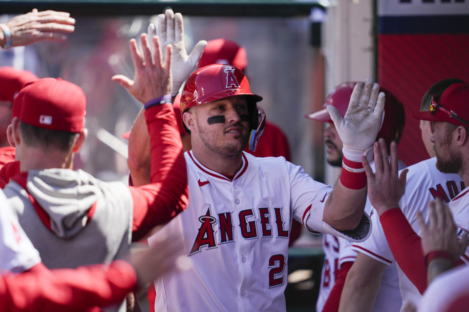 Los Angeles Angels designated hitter Mike Trout celebrates in the dugout after hitting a home run during the sixth inning of a baseball game against the Baltimore Orioles in Anaheim, Calif., Wednesday, April 24, 2024. (AP Photo/Ashley Landis)