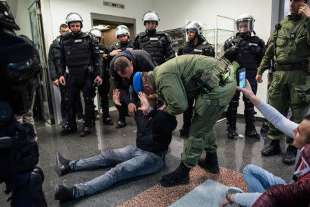 A man is removed after protesters briefly broke into Serbia's state television building during a protest against Serbian President Aleksandar Vucic and his government in central Belgrade, Serbia, March 16 , 2019. REUTERS/Stringer