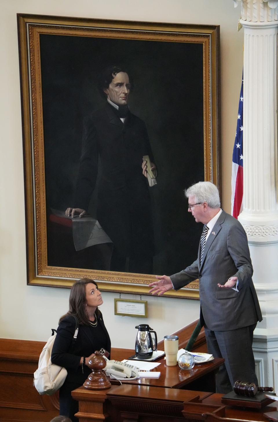 Lt. Gov. Dan Patrick talks to Sen. Angela Paxton, R-McKinney, in the Senate Chamber at the Capitol before the Senate considered the rules for the impeachment trial of her husband, suspended Attorney General Ken Paxton on June 20.