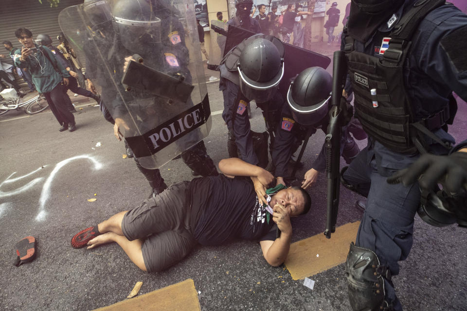 Police remove a fallen protester trying to march to the Asia-Pacific Economic Cooperation APEC summit venue, Friday, Nov. 18, 2022, in Bangkok, Thailand. (AP Photo/Wason Wanichakorn)