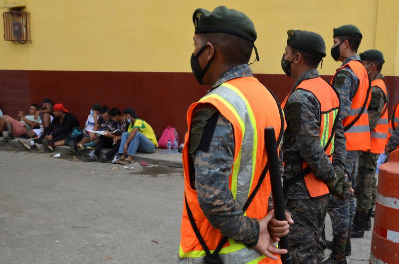 FILE PHOTO: Guatemalan soldiers form a line to prevent a group of Honduran migrants who are trying to reach the U.S, from moving towards the Guatemala and Mexico border, as they sit outside the migrant shelter , in Tecun Uman