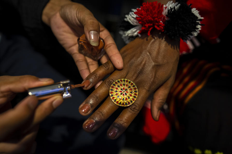 A participant prepares to participate in the Miss Trans Northeast 22, beauty pageant in Guwahati, India, Wednesday, Nov. 30, 2022. In a celebration of gender diversity and creative expression, a beauty pageant in eastern Indian state of Assam brought dozens of transgender models on stage in Guwahati. Sexual minorities across India have gained a degree of acceptance especially in big cities and transgender people were given equal rights as a third gender in 2014. But prejudice against them persists and the community continues to face discrimination and rejection by their families. (AP Photo/Anupam Nath)