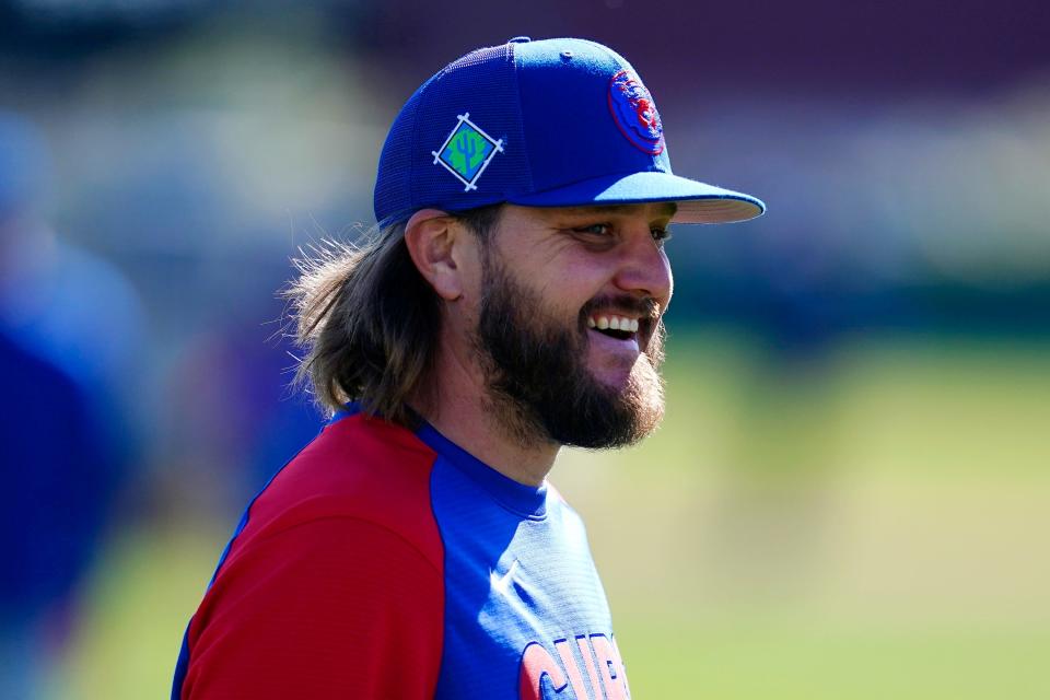 Chicago Cubs pitcher Wade Miley smiles as he talks with teammates during a spring training baseball workout Tuesday, March 15, 2022, in Mesa, Ariz. (AP Photo/Ross D. Franklin)